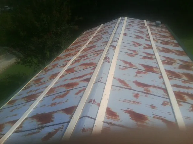 Rusted metal roof panels with new wood purlins before replacement — Storm Damage Roof Repair in Bakerstown by Roofing Brothers