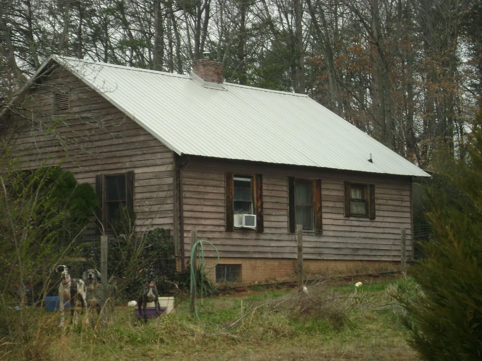 White metal roof on an old wood sided farmhouse, from a Metal Roof Installation job in Bakerstown